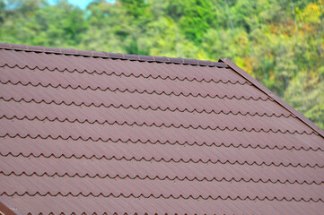 The roof of the house is covered with metal tiles