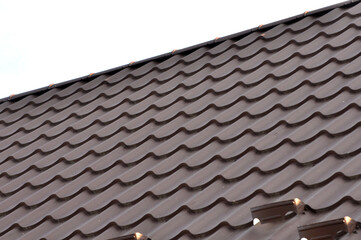 The roof of the house is covered with metal tiles