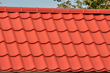 Fototapeta premium The roof of the house is covered with metal tiles