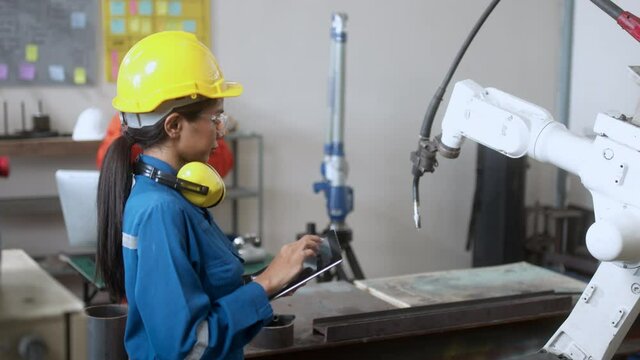 specialist technical engineer hand input programing code data computing to manage movement work flow of robotarm welding machinery in workshop modern factory smart industrial manufacture concept