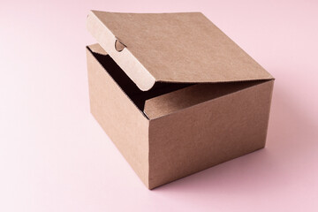 Open cardboard box for gift, parcels. Pink background
