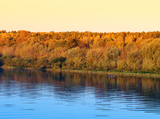 Boat on autumn river travel background