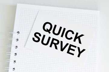 QUICK SURVEY Words written on a white card on a notepad