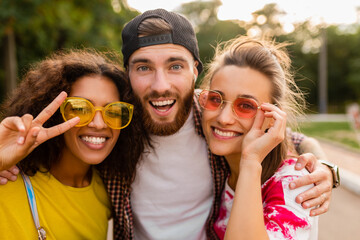 happy young company of friends having fun in park