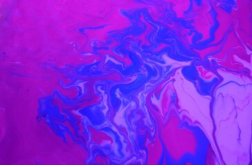 Fototapeta na wymiar Abstract background of blue-pink marble. Acrylic paint mixes freely and creates an interesting pattern. Bright saturated shades. Background for the cover of a laptop, laptop.