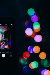 Fototapeta na wymiar Bokeh from a Christmas tree on a dark background