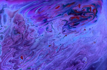 Abstract purple marble background. Acrylic paint mixes freely and creates an interesting pattern. Bright saturated shades. Background for the cover of a laptop, laptop.