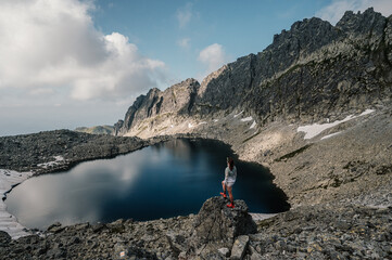 Mountain valley. Hiker stands on the rock in High Tatras national park , Furkotska dolina, Slovakia landscape.