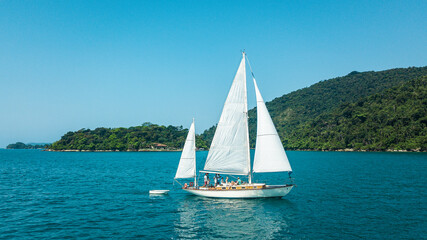 Beautiful classic sailboat sailing through the Paraty Bay, Rio de Janeiro, Brazil.