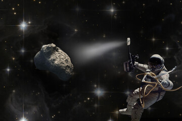 Obraz na płótnie Canvas Mission to save the Earth from asteroid fall. Astronaut in space illuminates meteorite. Concept of the victory of mankind over the cosmic threat. Collage. Elements of this image furnished by NASA.