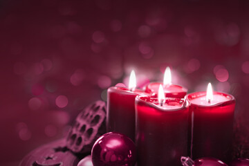Four burning red candles for Advent. Christmas background.