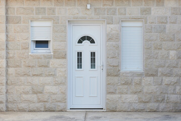White front door and stone wall in a residential building