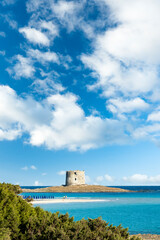 Fototapeta na wymiar Stunning landscape with the Aragonese Tower and La Pelosa Beach bathed by a calm turquoise water. Spiaggia La Pelosa, Stintino, north-west Sardinia, Italy.