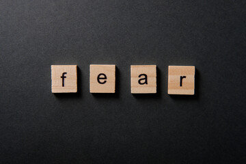 The inscription "fear" on a dark background