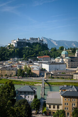 Naklejka premium View of Salzburg, the river Salzach and the mountains from the old Kapuzinerberg wall on a sunny summer day, Austria