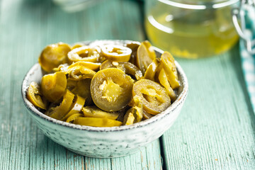 Pickled sliced jalapeno. Green jalapeno peppers in bowl.