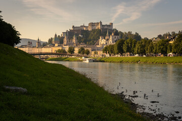 Panoramic view of Salzburg skyline with river Salzach in summertime at sunrise, Austria