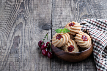Qurabiya cookie shortbread with jam on rustic wooden table