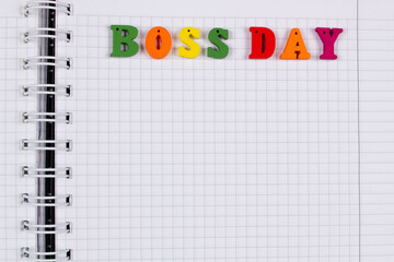 National Happy Boss Day. Multicolored colorful letters in a squared exercise book on the table....