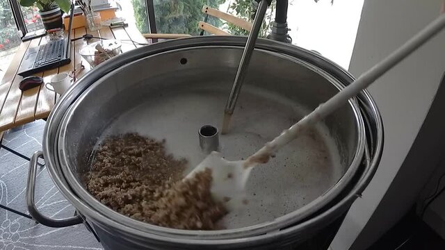 Beer brewing at home with a brewing machine. The numbers of home brewers is getting higher every day and more people engage in this hobby every day.