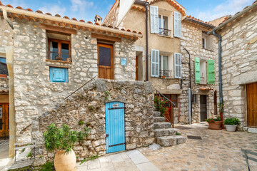A picturesque garden courtyard and alley in the medieval stone hilltop village of Gourdon in the...