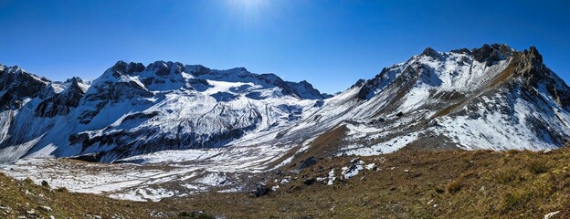 Snowy mountain landscape on the shady side. Hike above Sertig Davos. Ducan Glacier. Switzerland. Large peak panorama