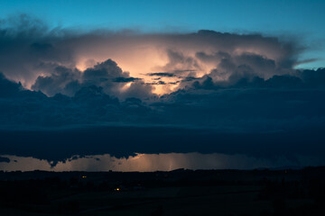 Dramatic looking lightning storm at the border of Austria and Germany during blue hour