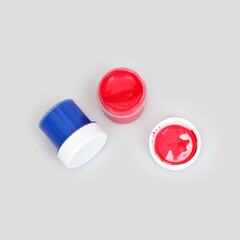 Bottles with multicolored gouache isolated on white background