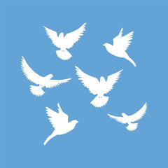 Set of white doves on a blue background. White doves are flying in the sky. 