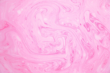 Abstract colored marble background, stains of pink paint on the surface of the water. Liquid colorful backdrop.