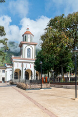 Fototapeta na wymiar Tamesis, Antioquia, Colombia. June 22, 2020: San Antonio de Tamesis parish with trees and blue sky.