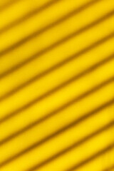 Perfect yellow leather background for design with oblique parallel stripes from the shadow, vertical photo, pattern