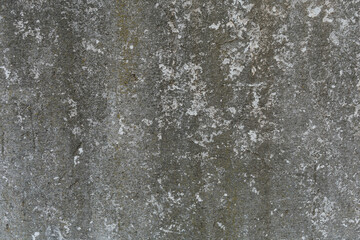 Old concrete wall texture with details of moisture and mold from the passage of time. Dark gray colors