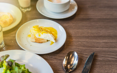 Healthy breakfast with Benedict egg, vegetable salad and tart in the morning.