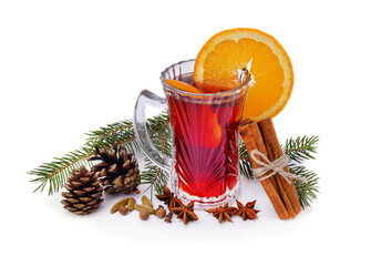 Cup of mulled wine with cinnamon sticks and a Christmas tree.