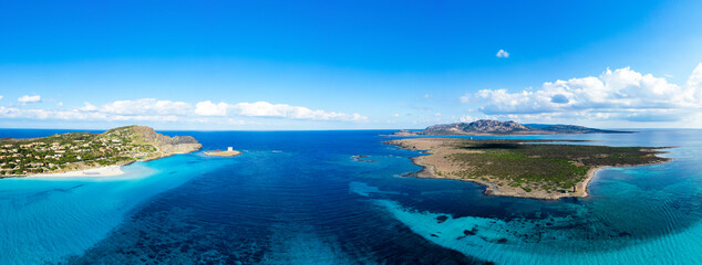 Fototapeta na wymiar View from above, aerial shot, stunning panoramic view of La Pelosa Beach and the Asinara island bathed by a turquoise, crystal clear water. Spiaggia La Pelosa, Stintino, north-west Sardinia, Italy.