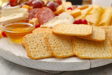 Platter with crunchy crackers and honey, closeup