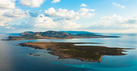 Naklejka na ściany i meble View from above, stunning aerial view the Asinara Island bathed by a turquoise water. Asinara is a small, uninhabited island that sits off the northwestern coast of Sardinia, Italy.