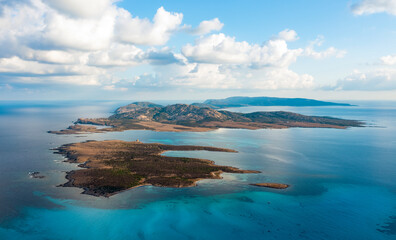 View from above, stunning aerial view the Asinara Island bathed by a turquoise water. Asinara is a small, uninhabited island that sits off the northwestern coast of Sardinia, Italy.