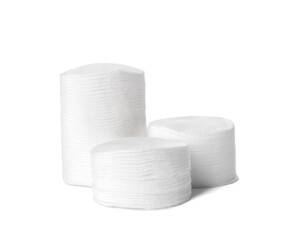 Stacks of cotton pads on white background