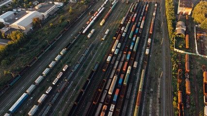 Fototapeta na wymiar Aerial View. Old defective and looted railway wagons stand on the territory of the repair depot awaiting repairs. Poor business management. Ukrainian railway, DVRZ.