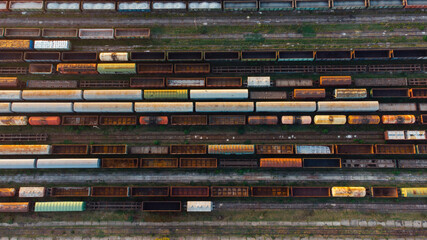 Aerial View. Old defective and looted railway wagons stand on the territory of the repair depot awaiting repairs. Poor business management. Ukrainian railway, DVRZ.