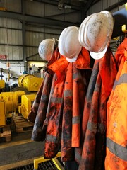 dirty and greasy hi viz workwear in an industrial environment