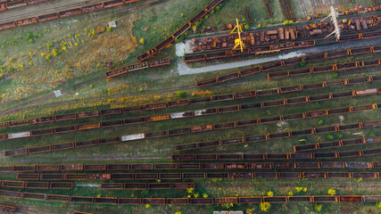 Aerial View. Old defective and looted railway wagons stand on the territory of the repair depot awaiting repairs. Poor business management. Ukrainian railway, DVRZ.