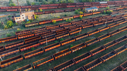 Aerial View. Old defective and looted railway wagons stand on the territory of the repair depot awaiting repairs. Poor business management. Ukrainian railway, DVRZ.
