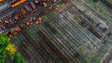 Aerial View. Old defective and looted railway wagons stand on the territory of the repair depot awaiting repairs. Poor business management. Ukrainian railway, DVRZ.