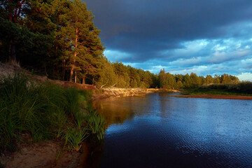 Fototapeta premium River landscape after rain. Sunset rays. Russia, Moscow region, Dubna river.