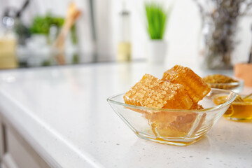 Bowl of honey combs on table in kitchen
