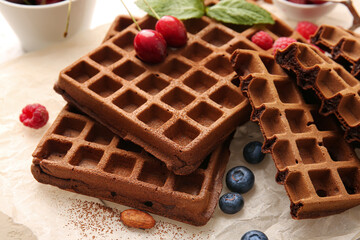 Delicious Chocolate Belgian Waffles with berries on parchment
