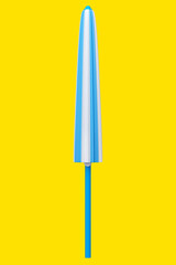 Blue striped beach umbrella for lounge zone on seashore isolated on yellow.